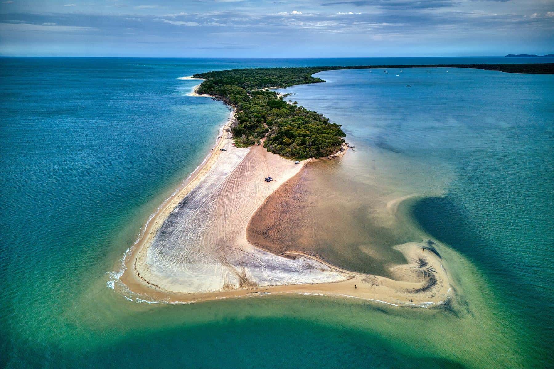 Calm water and sand at Inskip Point looking towards K’gari